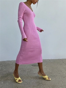 Close-up of pink long-sleeved ribbed knit dress showing slim fit and texture detail