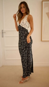 Detail shot of sleeveless long dress featuring contrast floral prints and a deep V-neckline