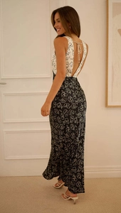 Close-up of deep V-neck tie detail on contrast floral print maxi dress with open back