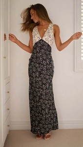 Detail view of contrast floral print on high-waist maxi dress with a deep V-neckline