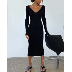 Detail of a slim fit black V-neck long sleeve midi knit dress with vertical rib textures
