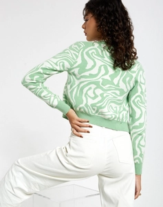 Detail of green and white wavy pattern knitwear with ribbed cuffs and waist