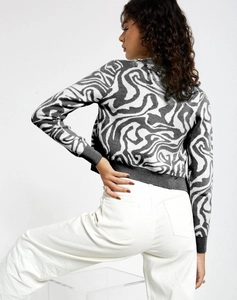 Detailed back view of a grey and white marble pattern knit cardigan on a model