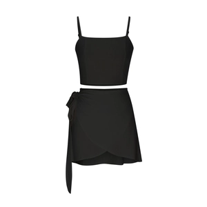 Detail of black two-piece set featuring thin strap crop top and side-tie wrap mini skirt