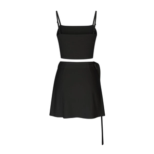 Detail of black smocked crop top with skinny straps and wrap skirt with tie side detail
