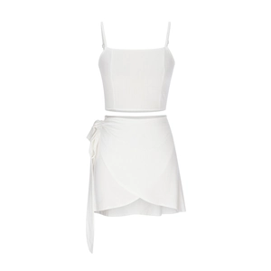 Detail of white two-piece summer set featuring a crop camisole and wrap mini skirt
