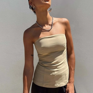 Sleek khaki tube top with structured seams and open back detail in a minimalist style