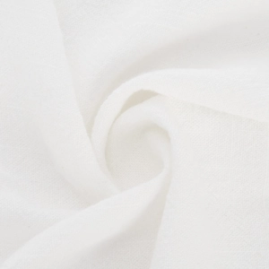 Close-up of pure white textured fabric with soft folds showing high-quality cotton linen weave