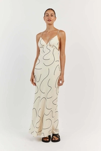 Detail of white floral maxi dress with slim straps and sleek abstract line art print