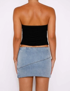 Rear view of model wearing a black bodycon tube top and a light blue denim mini skirt