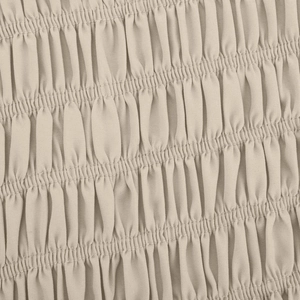 Detailed macro view of beige smocked elastic fabric with fine textured ruffle details