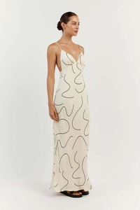 Detail of elegant backless floral maxi dress with deep V-neck and thin straps