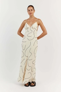 Detail of V-neck floral maxi dress featuring black abstract print on cream satin fabric