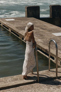 Detail view of backless maxi dress with abstract print and matching headscarf