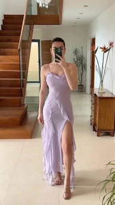 Close-up of lavender off-the-shoulder slit dress with ruffle detail and cowl neck