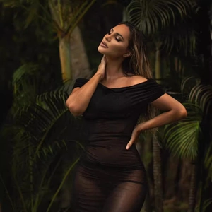 Elegant black off-the-shoulder mesh dress with slim fit design and sheer fabric finish