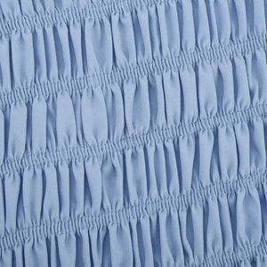 Close-up of light blue smocked fabric texture with elastic shirring on slim fit top