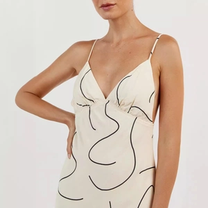 Sleeveless deep V-neck maxi dress with minimalist abstract black print on cream fabric