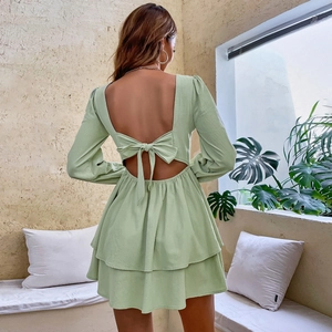 Detail of mint green backless tiered mini dress with elegant bow tie and puff sleeves