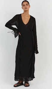 Detail of a black maxi dress with deep V-neck, lace-up sleeves and vertical seam accents