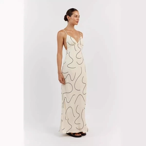 Deep V-neck backless floral maxi dress with thin straps and abstract print design