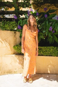 Close-up of summer orange V-neck strap dress with starfish print and ruffle detail