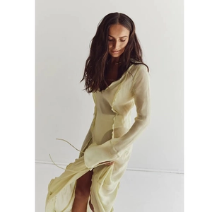 Elegant pale yellow sheer V-neck maxi dress with ruffles and flowing long sleeves