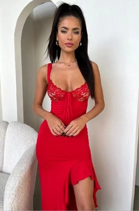 Close-up of red lace patchwork bodice with bow tie and ruffle hem on slim dress