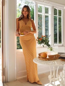 Elegant yellow V-neck halter maxi dress with geometric patterns for a summer vacation look