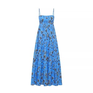Detail of blue tropical palm print summer dress with thin straps and tiered ruffled skirt