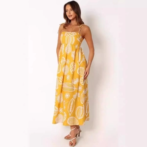 Close-up of yellow floral sundress featuring thin tie shoulder straps and fruit pattern