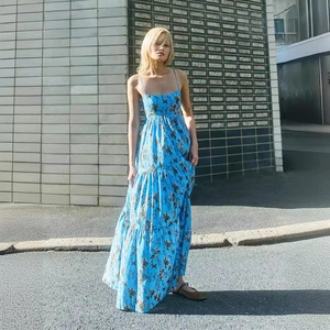 Close-up of blue floral maxi dress with layered cake skirt and delicate straps
