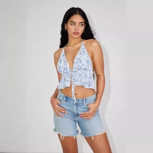 Women's summer floral halter crop top with drawstring detail and blue denim shorts
