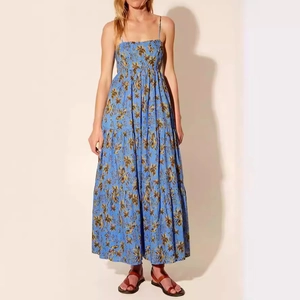 Detail view of sky blue floral maxi dress featuring tiered skirt and thin spaghetti straps