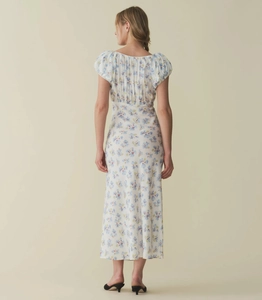 Detail of back view showing puff sleeves and shirred texture on white floral dress
