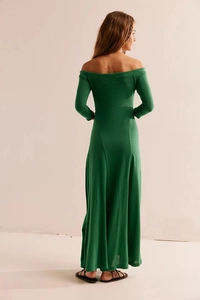 Detail view of the back seams and stitching on a dark green off-shoulder knit maxi dress