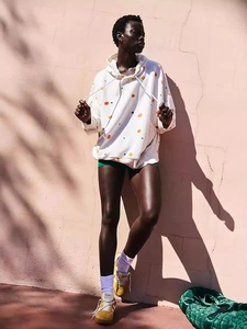Women's white oversized floral hoodie with orange and green prints for street style