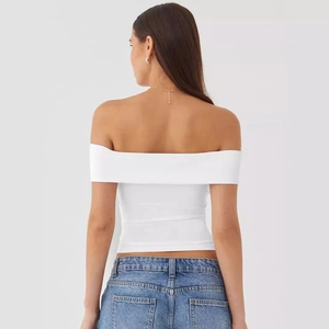 Rear view of off-shoulder slim-fit white top paired with classic blue denim jeans