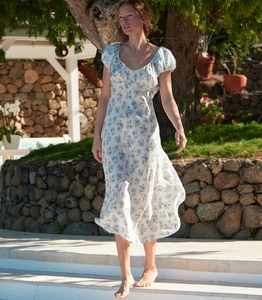 Close-up of white summer midi dress with blue floral print, U-neck, and puff sleeves