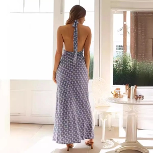 Detail of grey-blue backless halter maxi dress featuring white floral print and tie back