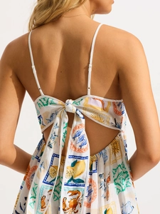 White floral backless maxi dress with Mediterranean prints and tie-back bow detailing