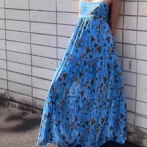 Detailed look at the tiered bohemian blue floral maxi dress made of light chiffon fabric