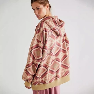 Detail view of women's oversized hoodie featuring retro geometric diamond pattern and ribbing