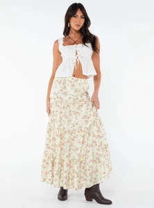 Detail of a tiered floral maxi skirt with ruffle trim crop top on a fashion model