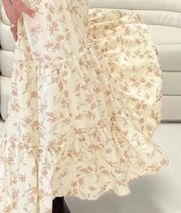 Detail view showing multi-layered ruffled cake skirt with pink floral print pattern