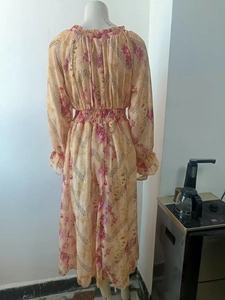 Detailed close-up of floral chiffon dress featuring elastic waist and ruffle neck design
