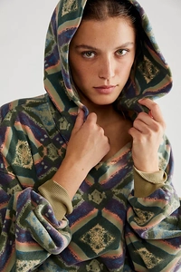 Detail of bohemian geometric print hoodie with mustard ribbed cuffs and loose fit