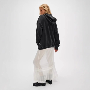 Detail view of black oversized wash-textured hoodie with dropped shoulder and large hood