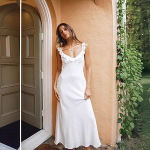 Elegant white V-neck maxi dress with ruffle trim and thin straps for summer vacations