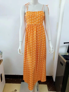 Bohemian orange high waist maxi dress with white geometric floral patterns and tie straps